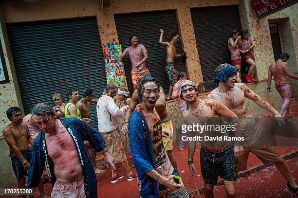 Revellers throw tomato pulp while participating the annual Tomatina festival on August 28, 2013 in Bunol, Spain. An estimated 20,000 people threw 130...