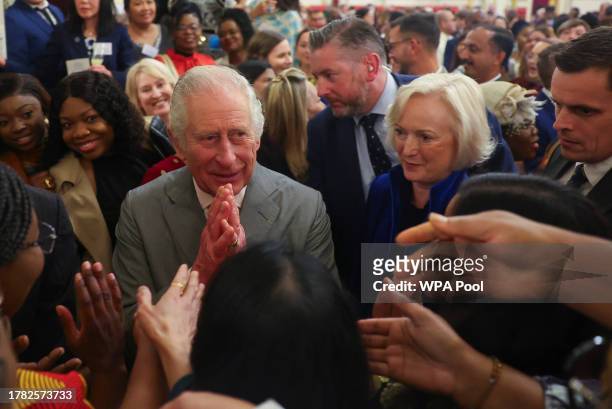 Britain's King Charles III and Chief Nursing Officer for England Ruth May , speak to guests as they meet nurses and midwives to celebrate their work...