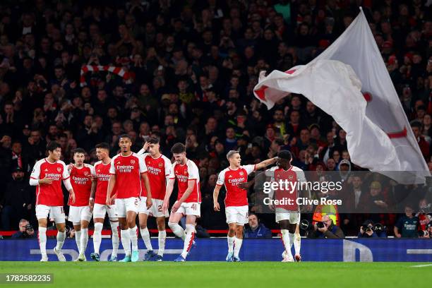 Leandro Trossard of Arsenal celebrates after scoring the team's first goal with teammate Bukayo Saka during the UEFA Champions League match between...