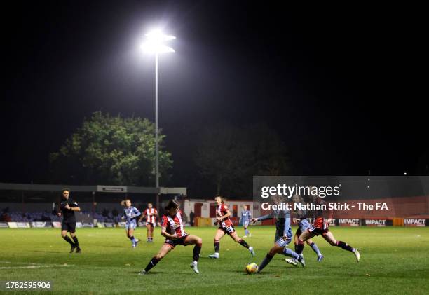 Kirsty Hanson of Aston Villa runs past Charley Docherty of Sheffield United during the FA Women's Continental Tyres League Cup match between...