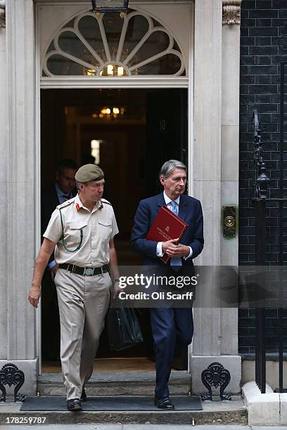 British Defense Secretary Philip Hammond leave Number 10 Downing Street with the Chief of the Defense Staff, General Sir Nick Houghton, on August 28,...