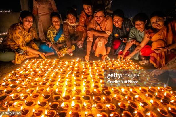 Devotees light earthen oil lamps on the occasion of Dev Deepavali. Dev Deepavali, also known as Diwali of the Gods, is a festival celebrated on...