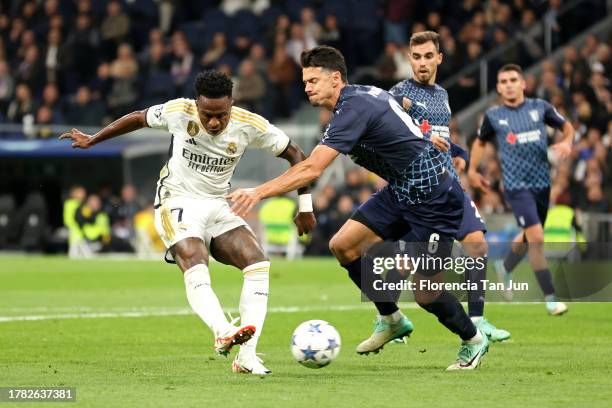 Vinicius Junior of Real Madrid scores the team's second goal past Jose Fonte of SC Braga during the UEFA Champions League match between Real Madrid...