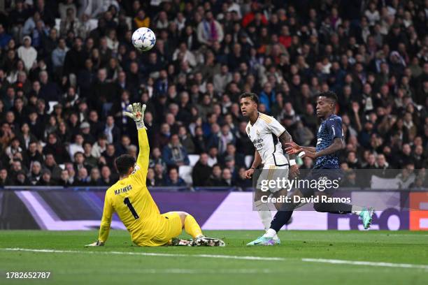 Rodrygo of Real Madrid scores the team's third goal past Matheus Magalhaes of SC Braga during the UEFA Champions League match between Real Madrid and...