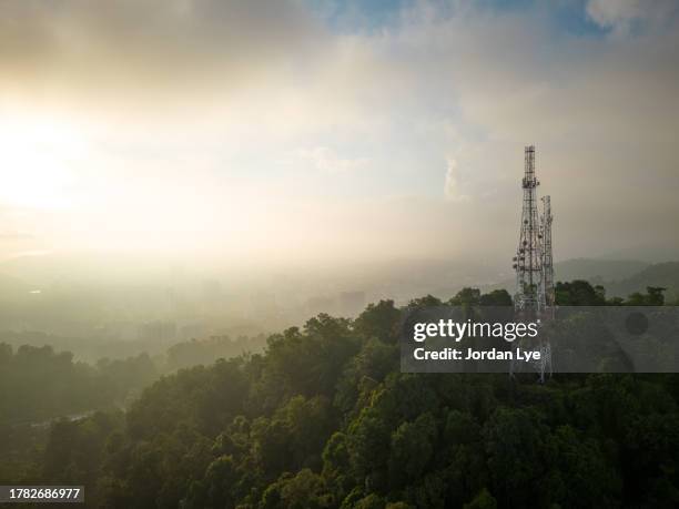 city telecommunication tower in greenery and sunrise, aerial view - telecommunications tower stock pictures, royalty-free photos & images