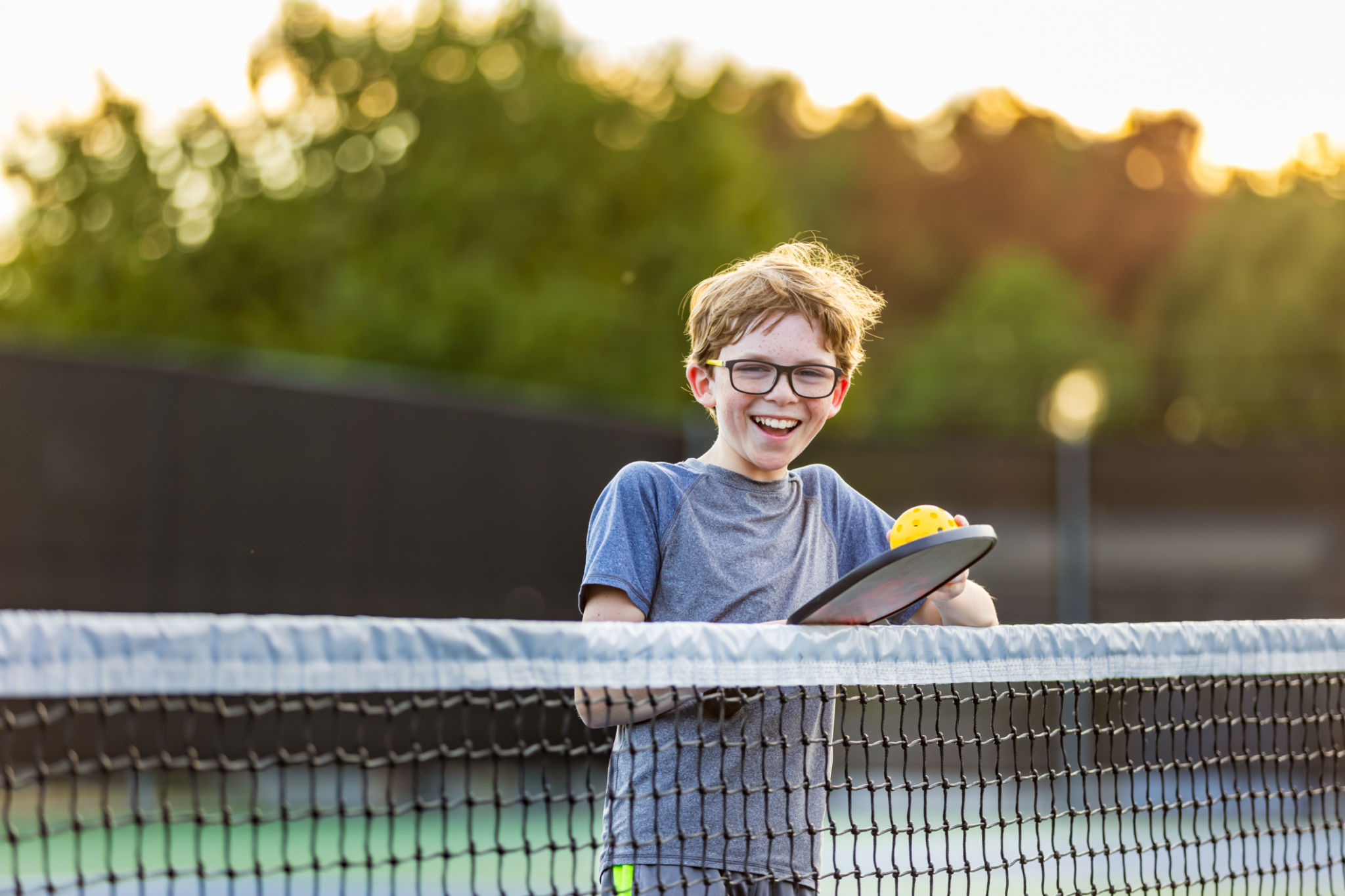 Boy on court with Pickleball gear Boy on court with Pickleball gear