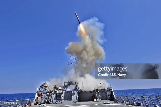 In this handout released by the U.S. Navy, the U.S. Navy guided-missile destroyer USS Barry launches a Tomahawk cruise missile in support of...