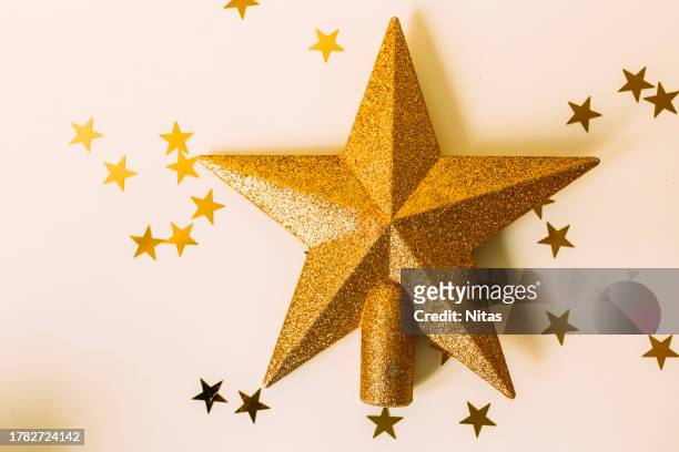 tree topper golden star shape - tree topper stock pictures, royalty-free photos & images