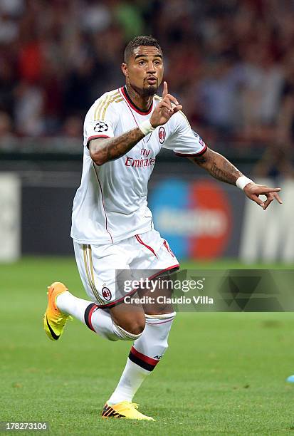 Kevin Prince Boateng of AC Milan celebrates scoring the first goal during the UEFA Champions League Play-off Second Leg match between AC Milan v PSV...