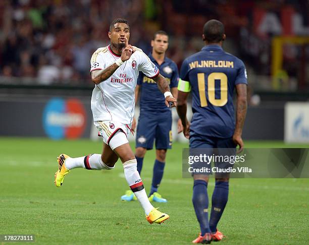 Kevin Prince Boateng of AC Milan celebrates scoring the first goal during the UEFA Champions League Play-off Second Leg match between AC Milan v PSV...