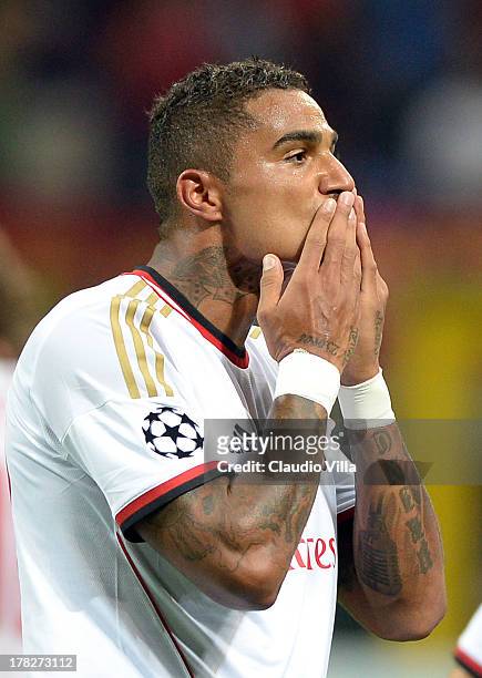 Kevin Prince Boateng of AC Milan celebrates scoring the first goal during the UEFA Champions League Play-off Second Leg match between AC Milan v PSV...