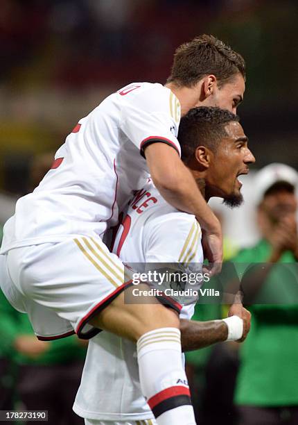 Kevin Prince Boateng of AC Milan celebrates scoring the first goal during the UEFA Champions League Play-off Second Leg match between AC Milan v PSV...