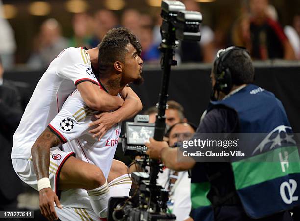 Kevin Prince Boateng of AC Milan celebrates scoring the first goal during the UEFA Champions League Play-off Second Leg match between AC Milan v PSV...