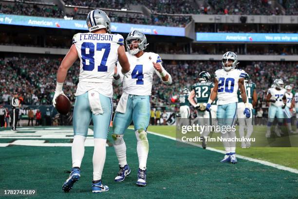 Jake Ferguson and Dak Prescott of the Dallas Cowboys react after a touchdown against the Philadelphia Eagles at Lincoln Financial Field on November...