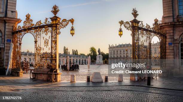 place stanislas (stanislaw square) as seen from the south-west entrance at the golden hour with the rococo gilded grates lighted by the sun, nancy, meurthe et moselle, lorraine, eastern france. - stanislas stock pictures, royalty-free photos & images