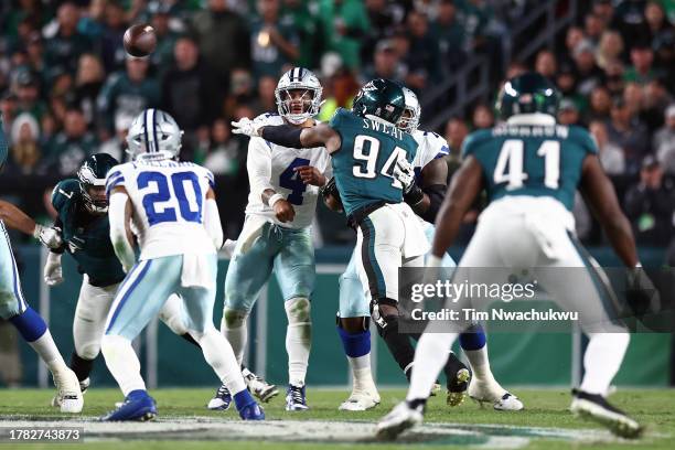 Dak Prescott of the Dallas Cowboys passes past Josh Sweat of the Philadelphia Eagles at Lincoln Financial Field on November 05, 2023 in Philadelphia,...