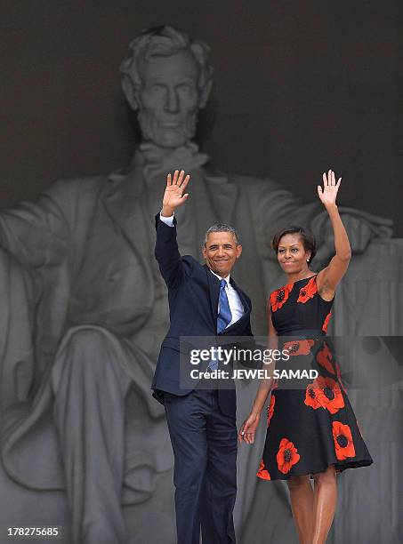 President Barack Obama and First Lady Michelle Obama wave during the Let Freedom Ring Commemoration and Call to Action to commemorate the 50th...