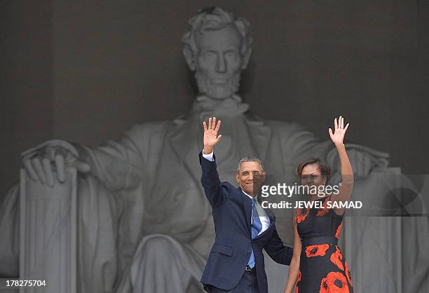 President Barack Obama and First Lady Michelle Obama wave during the Let Freedom Ring Commemoration and Call to Action to commemorate the 50th...