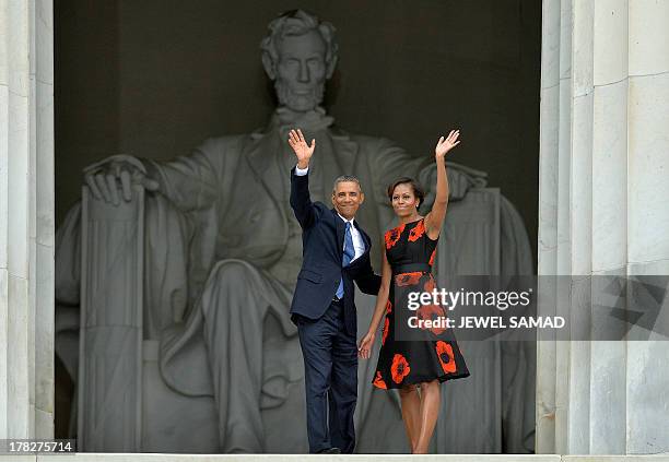 President Barack Obama and First Lady Michelle Obama wave during the Let Freedom Ring Commemoration and Call to Action to commemorate the 50th...