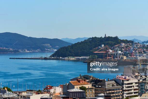 high angle view of the port of vigo with buildings, the sea and a mountain in the background. - pontevedra province ストックフォトと画像