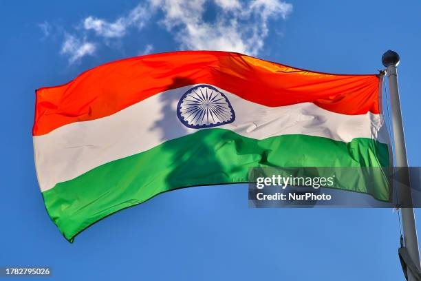 Indian flag flutters against a blue sky in Richmond Hill, Ontario, Canada, on November 13, 2023.