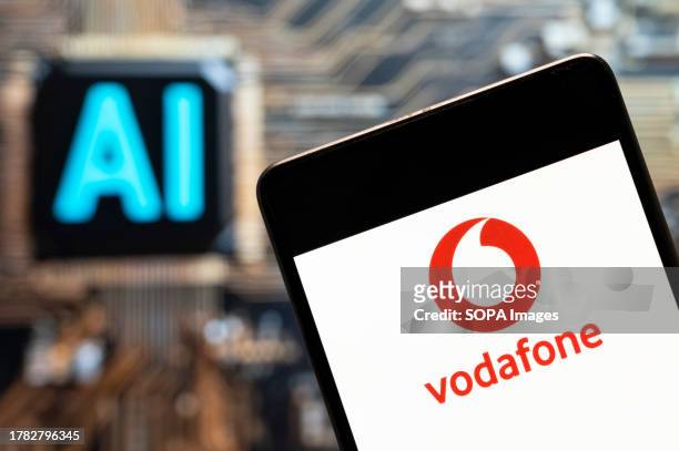 In this photo illustration, the British multinational telecommunications corporation and phone operator Vodafone logo seen displayed on a smartphone...
