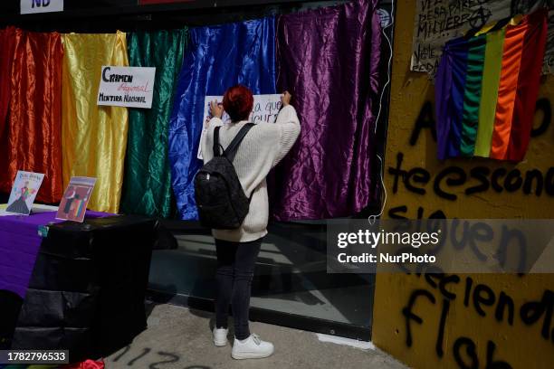 Students from the Faculty of Political and Social Sciences of the National Autonomous University of Mexico, place banners at an offering in memory of...
