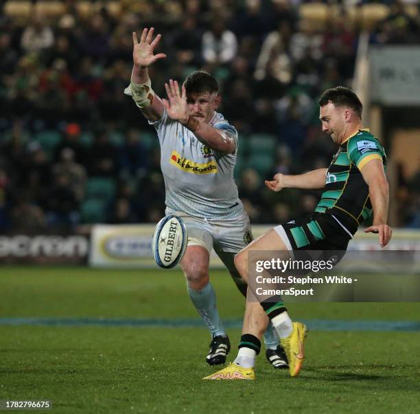 Northampton Saints' Tom James kicks as Exeter Chiefs' Jacques Vermeulen attempts to block during the Gallagher Premiership Rugby match between...