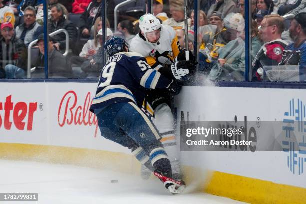 Yegor Chinakhov of the Columbus Blue Jackets checks Marcus Pettersson of the Pittsburgh Penguins in the first period of game at Nationwide Arena on...