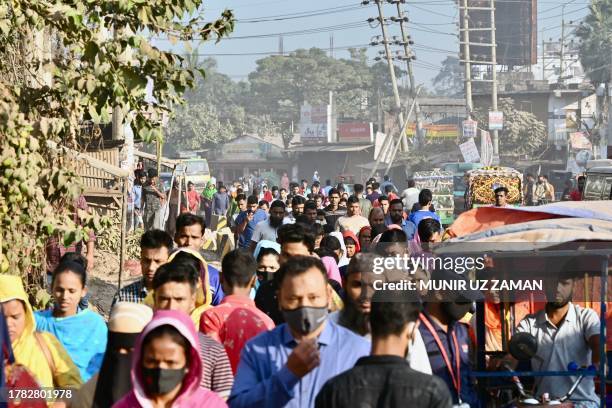 Bangladeshi garment workers enter their factory as they return to work in Ashulia, north of Dhaka on November 15 after garment factories in Ashulia...