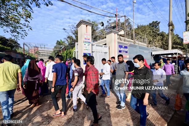 Bangladeshi garment workers enter their factory as they return to work in Ashulia, north of Dhaka on November 15 after garment factories in Ashulia...