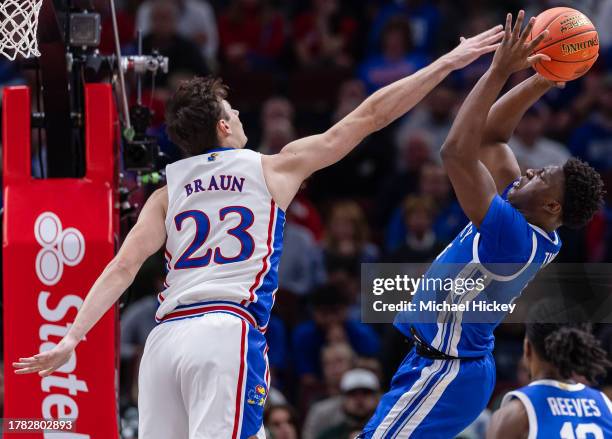 Parker Braun of the Kansas Jayhawks defends against the shot from Adou Thiero of the Kentucky Wildcats during the first half in the 2023 State Farm...