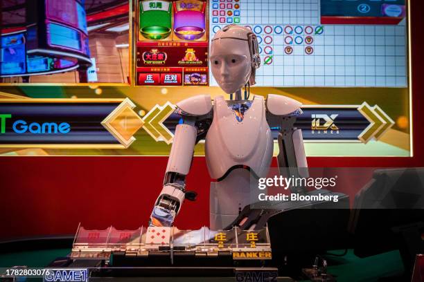 Robot croupier deals playing cards at the Macau Gaming Show in Macau, China, on Tuesday, Nov. 14, 2023. Macau's casinos have largely stayed on a...