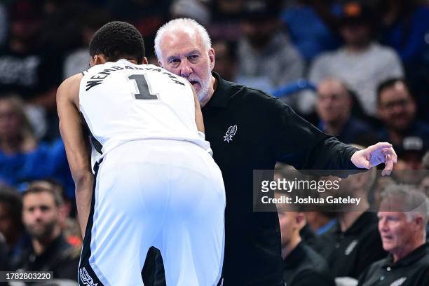 Head coach Gregg Popovich of the San Antonio Spurs speaks to Victor Wembanyama during the second half of an NBA In-Season Tournament game against the...