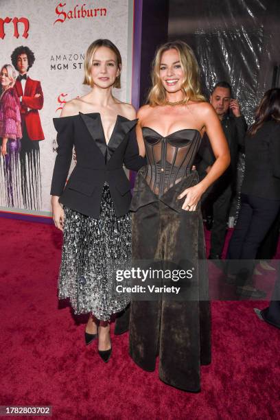 Carey Mulligan and Margot Robbie at the premiere of "Saltburn" held at The Theatre at Ace Hotel on November 14, 2023 in Los Angeles, California.