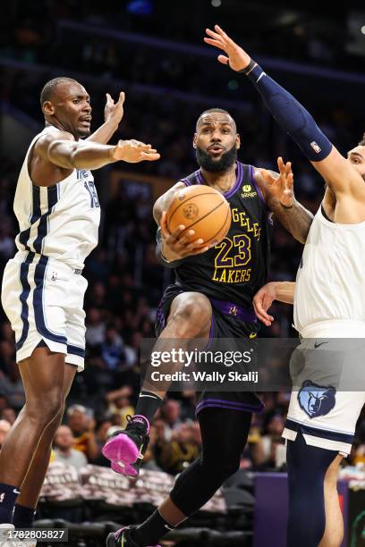 Los Angeles, CA Los Angeles Lakers LeBron James goes up between between Memphis Grizzlies' Bismack Biyombo and David Roddy during the third quarter...