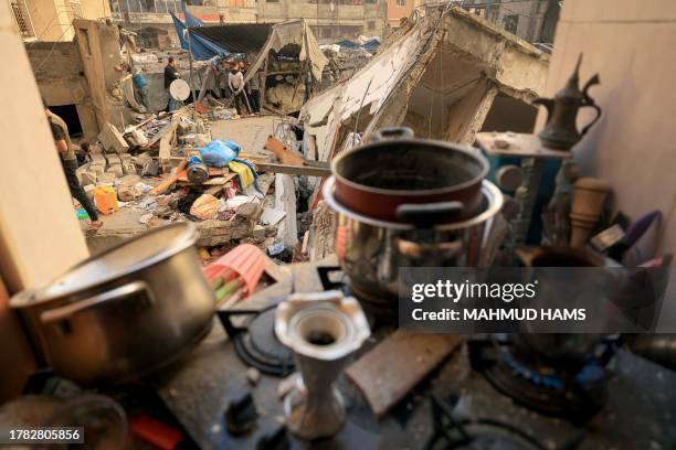 Pot of Arabic coffee brews on a stove following the early morning Israeli bombardment of homes in Khan Yunis in the southern Gaza Strip on November...