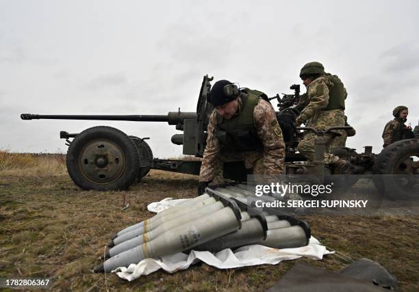 Ukrainian servicemen prepare artillery ammunition during in an anti drone drill in Chernigiv region on November 11, 2023.
