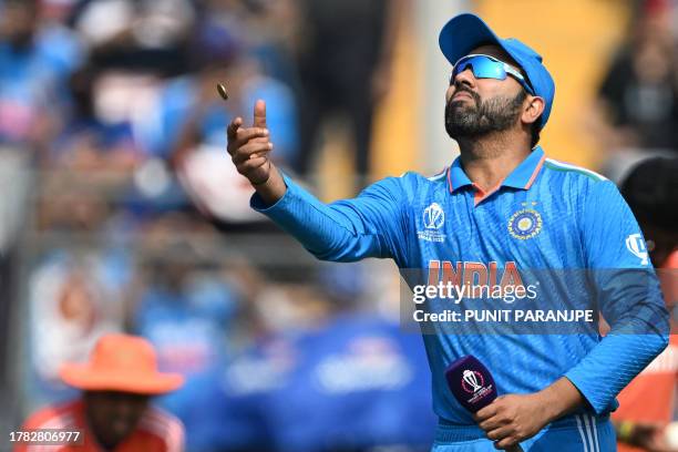 India's captain Rohit Sharma tosses the coin before the start of the 2023 ICC Men's Cricket World Cup one-day international first semi-final match...