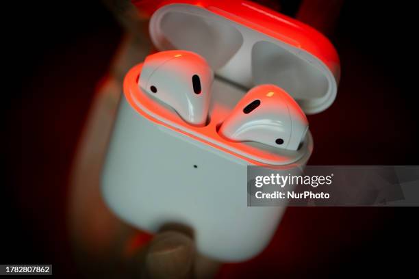 Pair of Apple AirPods wireless earbuds headphones are seen in this illustration photo on 15 November, 2023.