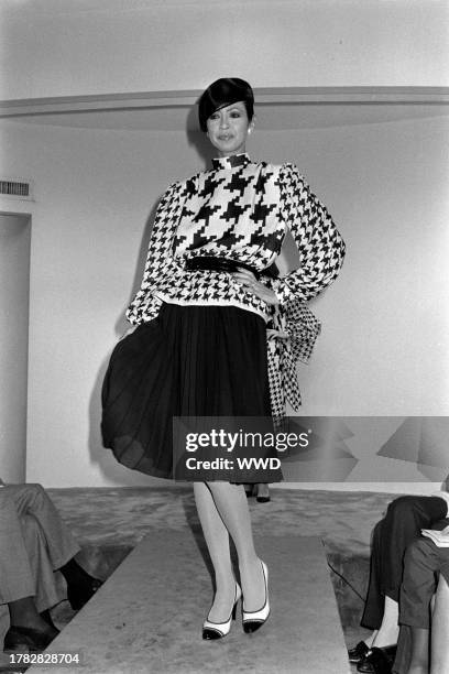 Model Anna Moll Moers presents an ensemble from the spring 1985 ready to wear collection inside of designer Pauline Trigère's New York City showroom.