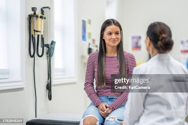 teenager at a medical appointment - teen and doctor stock pictures, royalty-free photos & images