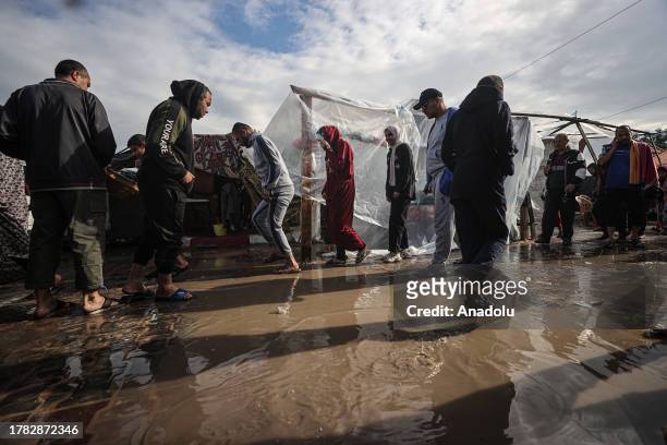 Children, adults are seen in the United Nations Relief and Works Agency refugee camp located in Khan Yunis, Gaza where displaced Palestinian families...