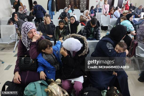 People wait at the traveller's terminal on the Palestinian side of the Rafah border crossing with Egypt in the southern Gaza Strip to have their...