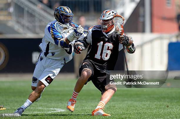 Terry Kimener of the Denver Outlaws battles against Casey Cittadino of the Charlotte Hounds during the 2013 MLL Semifinal game at PPL Park on August...