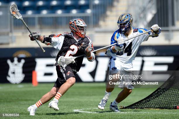 Brendan Mundorf of the Denver Outlaws battles for the ball against Joe Cinosky of the Charlotte Hounds during the 2013 MLL Semifinal game at PPL Park...