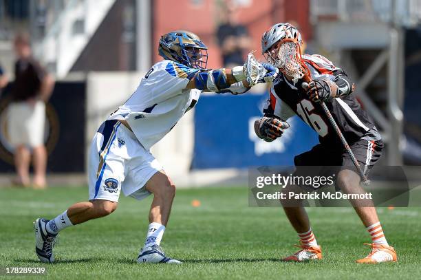 Terry Kimener of the Denver Outlaws battles against Casey Cittadino of the Charlotte Hounds during the 2013 MLL Semifinal game at PPL Park on August...