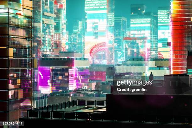 man standing on the building rooftop looking at the city at night - cyberpunk stock pictures, royalty-free photos & images