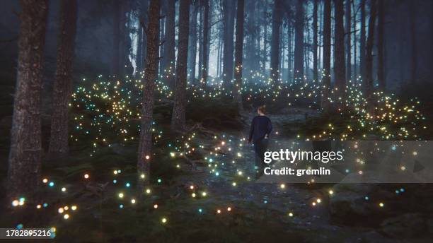 young woman walking in fantasy forest - fantasie stockfoto's en -beelden