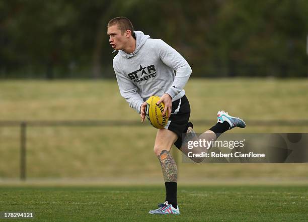 Dayne Beams of the Magpies runs with the ball during a Collingwood Magpies AFL training session at Olympic Park on August 29, 2013 in Melbourne,...